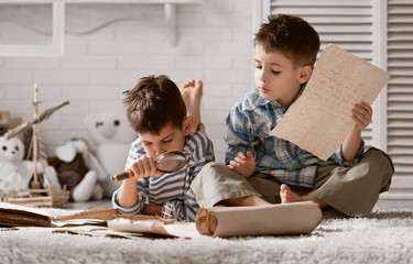 Two boys studying old maps Travel