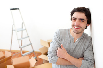 Portrait of a relaxed young man in his new flat