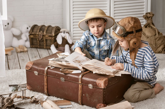 Boys in images traveler and pilot play in his room