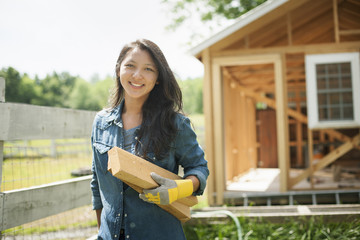 A young woman on a traditional farm in the countryside of New York State, USA
