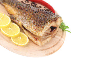 Baked fish on wooden board