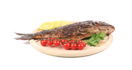 Baked fish on wooden board