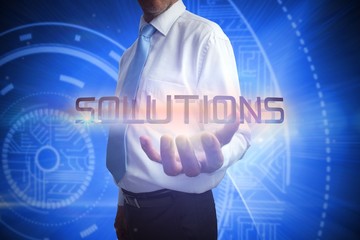 Businessman presenting the word solutions