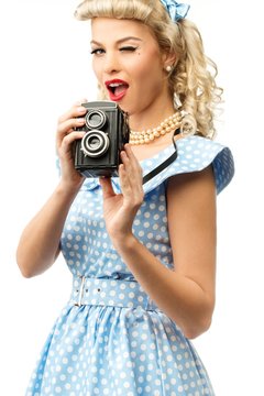 Sexy blond pin up style young woman in blue dress