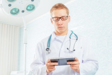 Physician works on a tablet computer in a clinic