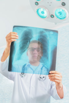 Doctor looks at x-ray image of lungs in a hospital