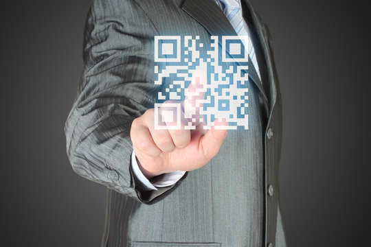 Businessman with hand pressing virtual qr code button - Powered by Adobe