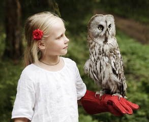 Cute girl with bird outdoors