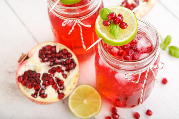 Two glasses with red pomgranate juice, lime and mint.