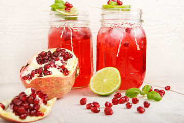 Two glasses with red pomgranate juice, lime and mint.