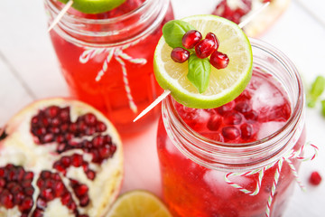 Two glasses with red pomgranate juice, lime and mint.