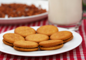 Double layer cream cookies with glass of milk
