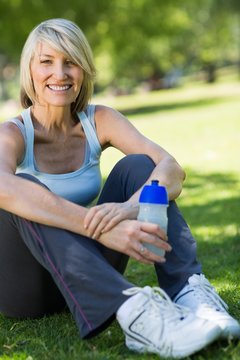 Woman holding water bottle in park