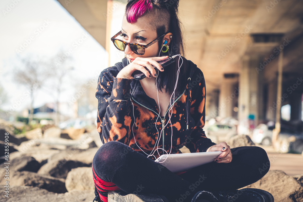 Wall mural young beautiful punk dark girl using tablet