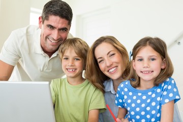 Portrait of happy family using laptop