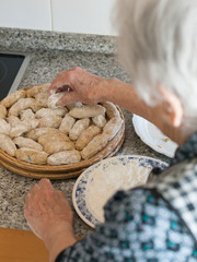 Elderly woman preparing croquettes