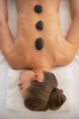 Young woman receiving hot stone massage
