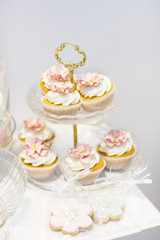 Elegant sweet table with cupcakes and other sweets for dinner or