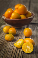 tasty kumquats on a wooden top