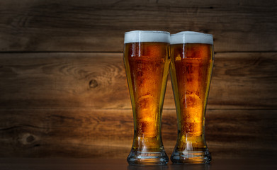 glasses of beer on wooden background