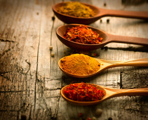 Spices. Curry, saffron, turmeric, cinnamon over wood