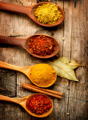 Various spices and herbs over wooden background