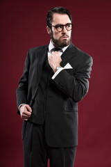 Retro 1900 fashion man with beard wearing grey suit black tie an