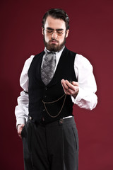 Retro 1900 victorian fashion man with beard wearing black gilet