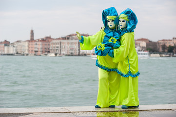 Fototapeta na wymiar Carnival of Venice, beautiful masks at St. George island with Ma