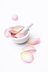 Mortar and Pestle with pink rose petals.