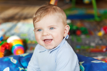 Portrait of cute baby boy of 6 months at home.