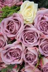 Purple roses in a wedding arrangement