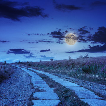 road of concrete slabs uphill to the night sky