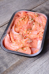 Salmon with spices on a wooden carving board