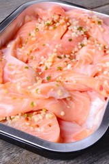 Salmon with spices on a wooden carving board