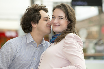 Love couple in shopping center kissing