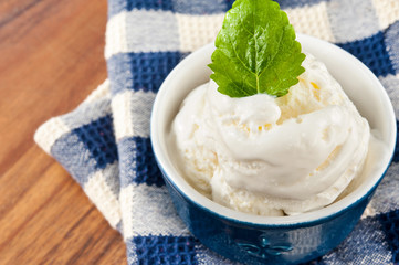 White vanilla ice-cream with green mint. Closeup.