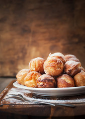 Donuts with Powdered Sugar on White Plate