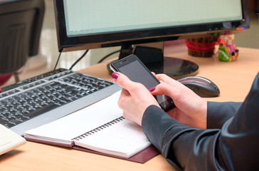 Woman uses a mobile phone. Office work