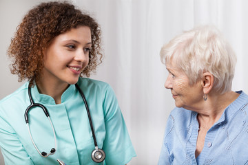 Nurse talking with elderly patient
