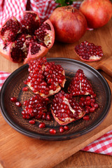 Ripe pomegranates on table close-up