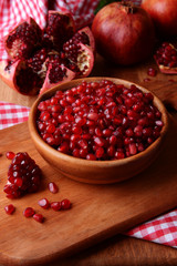Ripe pomegranates on table close-up