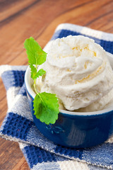 White vanilla ice-cream with green mint leaf. Closeup