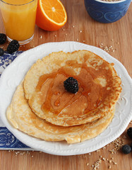 Pancakes with syrup and orange juice