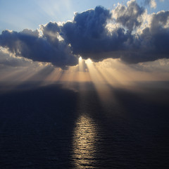 Clouds and rays of sun above the sea.
