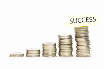 Isolated coins stacked with success label on top