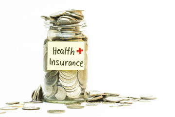 Isolated coins in jar with health insurance label