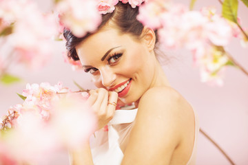 Obraz na płótnie Canvas Glad smiling woman with flowers in hair