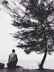 man sitting on the beach
