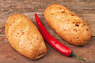 Two loaves of bread and a pepper